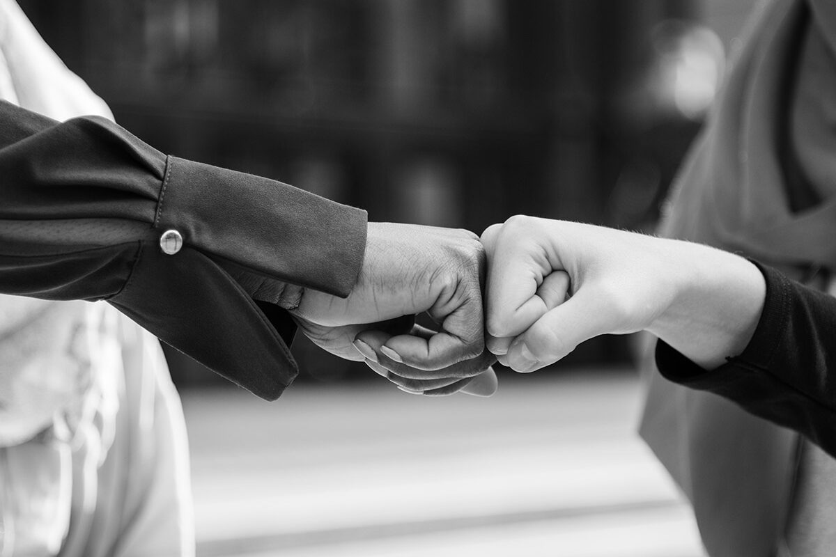 Islamic women friends fist bumps